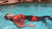 Pin-Up Girl swims fully clothed in pool