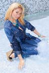 Blonde girl playing fully clothed in water