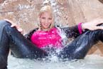 blonde asian girl fully clothed under waterfall